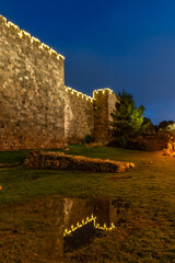 Section of the ramparts and walls of the Old City of Jerusalem, illuminated by decorative lights on Mt. Zion. © Yehoshua Halevi
