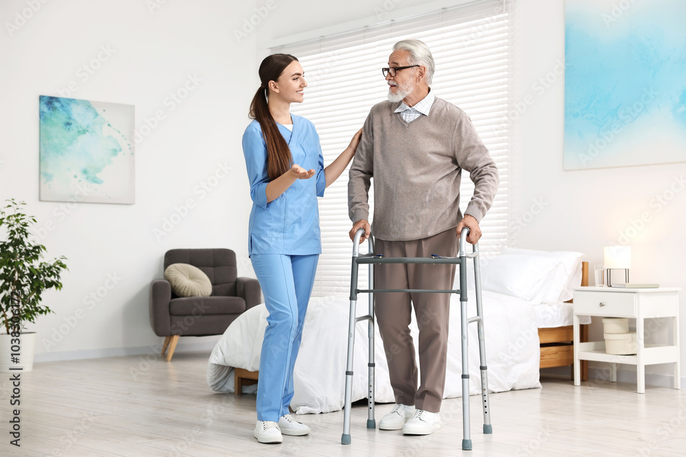 Wall mural nurse helping senior man with walking frame in clinic