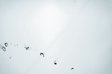 Water splash isolated on blue background. Transparent realistic water with movement and drops. Dynamic flight of water drops.