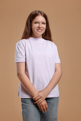 Obraz premium Portrait of teenage girl on beige background