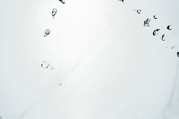 Water splash isolated on blue background. Transparent realistic water with movement and drops. Dynamic flight of water drops.