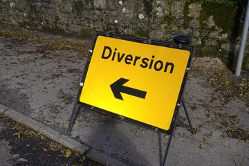 Diversion road sign with arrow. Detour route due to road works maintenance. 