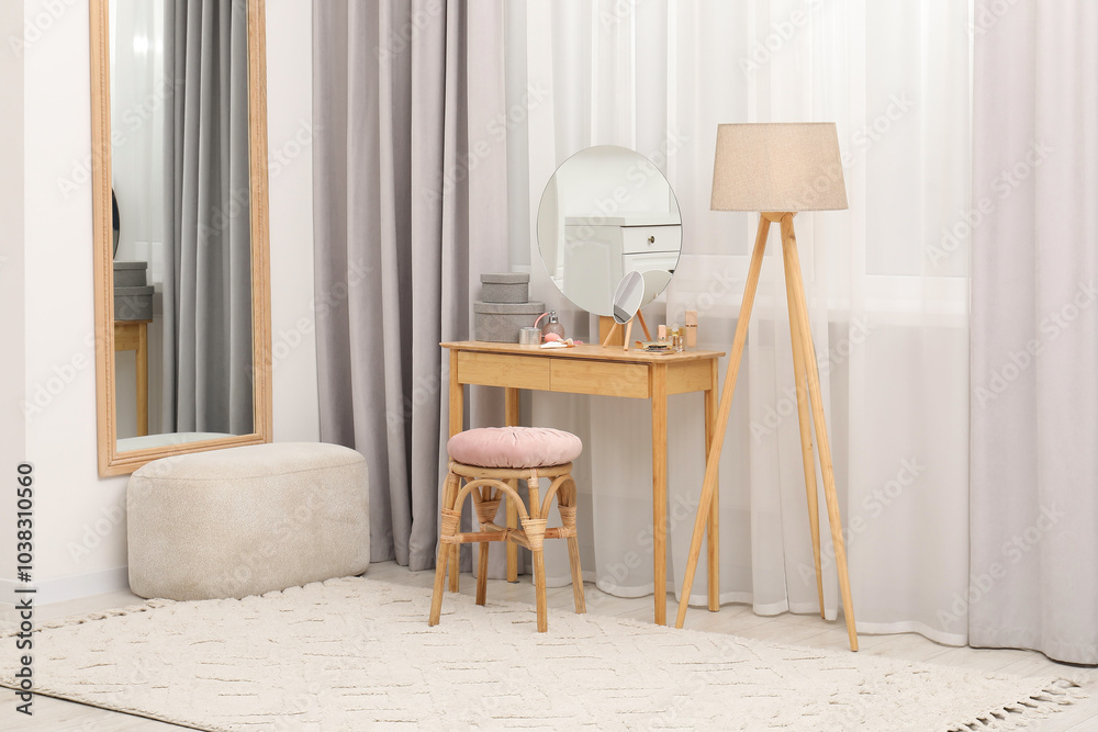 Wall mural Mirrors, dressing table, lamp and stool near window indoors. Interior design