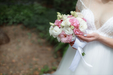 Wedding bouquet in the hands of the bride at the ceremony. Touching the hands of the bride and groom. Wedding jewelry. Wedding rings. The tenderness and beauty of the wedding ceremony.