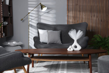 Stylish living room with folding screen and sofa. Interior design