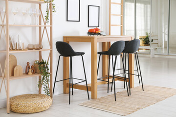 Bar stools near wooden table in room