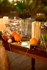 Gold candlesticks on wedding tables. Warm autumn palette. Transparent and lightweight composition