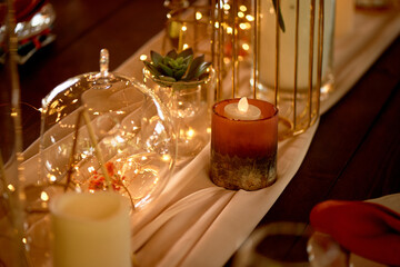 Gold candlesticks on wedding tables. Warm autumn palette. Transparent and lightweight composition