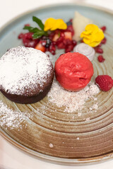 Chocolate Fondant with Strawberry Ice Cream: A Decadent Dessert Temptation. chocolate fondant, gooey center, rich dessert, moist cake, strawberry ice cream, gourmet dessert, fine dining, restaurant de