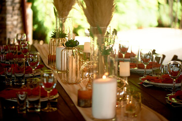 Gold candlesticks on wedding tables. Warm autumn palette. Transparent and lightweight composition