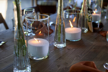 Wedding decoration. Floristics. Vessels with candles and bulk wax. Transparency and ease of design. Blue flowers and pampas.