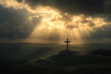 Fototapeta premium A cross on a hilltop illuminated by rays of sunlight breaking through dark clouds.