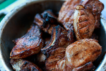 Juicy grilled steaks. Barbecue on the street. Cooking meat on the barrel with a grill.
