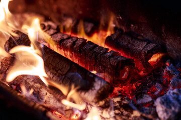 Burning wood for cooking on the grill. Tongues of flame, smoke, coal and ash. Burning hot charcoal....
