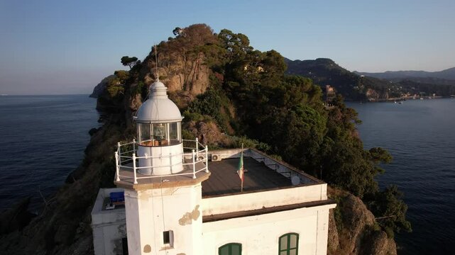  the historic Portofino lighthouse at sunset surrounded by stunning coastal views