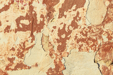 A fragment of a wall with red tints and yellow tint in the style of the 90s. Severe scratches and surface damage.