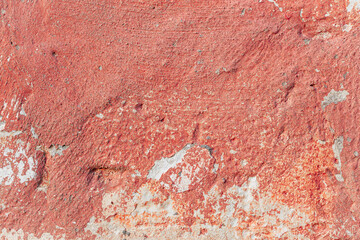 Grunge red concrete background. Textured plaster wall. Color of the year 2025 concept. Top view, layout for design. Surface with peeling shabby pattern.