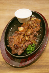 Plate of Arabian Beef Steak with Caramelized Onion Sauce and Yogurt Dip