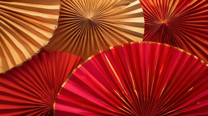 Close-up of red and gold paper fans.