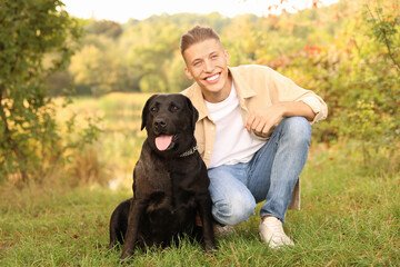 Smiling man with cute dog outdoors on autumn day