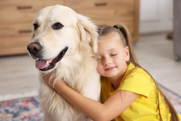 Girl with her cute Golden Retriever dog at home