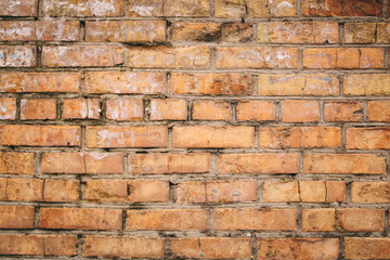 Non-linear pattern of an old shabby brick wall with natural patterns of paint chips. Restoration of semi-antique brick walls. A basic neutral background for a design project.