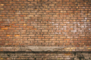 Non-linear pattern of an old shabby brick wall with natural patterns of paint chips. Restoration of semi-antique brick walls. A basic neutral background for a design project.