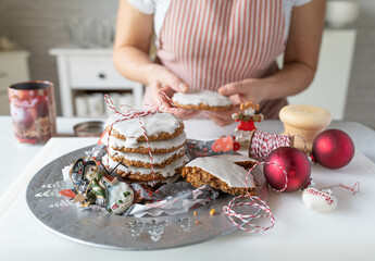 Homemade christmas gingerbread cookies fresh decorated by a woman in the kitchen. Traditional german elisen gingerbread
