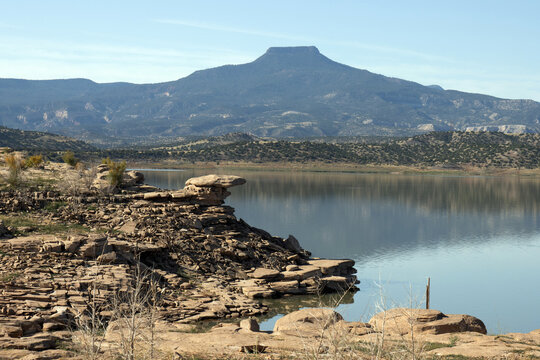 Famous landmark Cerro Pedernal and its reflection loom over Abiquiu Lake, an Army Corps of Engineers reservoir in northern New Mexico, at dawn