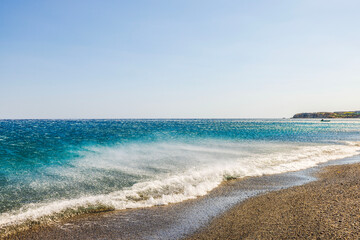 Offshore wind blowing waves away from rocky beach, Mediterranean Sea, Crete island.