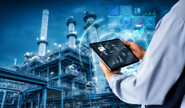 Smart industry 4.0 mangement control system concept.Hands holding tablet on blurred Chemical plant refinery industrial equipment as background