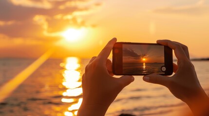 Close up of a woman hands taking a picture at sunset beach