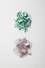 Stationery, paper clips, binders on a white background. Top view, flat lay