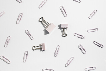 Stationery, paper clips, binders on a white background. Top view, flat lay