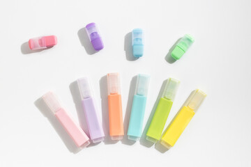 Colored markers pens on a white background. Top view, flat lay