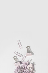 Stationery, paper clips, binders on a white background. Top view, flat lay