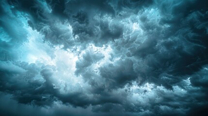 Obraz premium A dramatic sky with dark storm clouds contrasted by bright sunlight breaking through