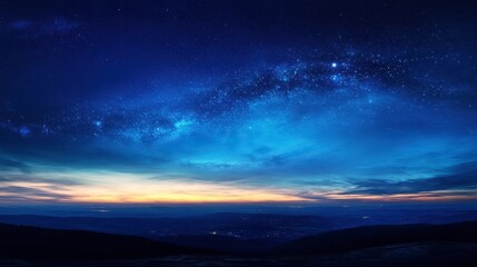 Fototapeta premium The sky transitioning from day to night, with a deep blue hue and the faint glow of stars and the galaxy.