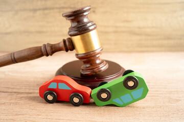 Car accident lawsuit and insurance, Judge hammer with car model.