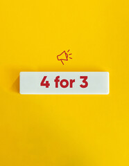 4 for 3 Banner. Deal, Promotional Offer, Campaign, Sale. Megaphone Icon and Text on Block Letter Tile on Yellow Background. Minimal Aesthetic.Letter Tiles on Yellow Background. Minimal Aesthetic.