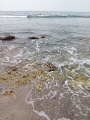Waves crashing against the rocks on the shore