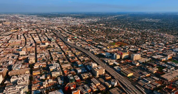 Immense panorama of Los Angeles, California, USA. Wide-lane highway is full of transport. Aerial view.