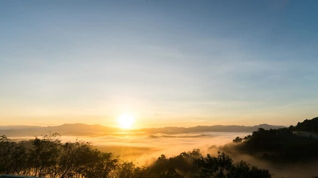 Wide angle First light in sunrise morning rolling sea of clouds in the mountain, beautifull sky background, time-lapse