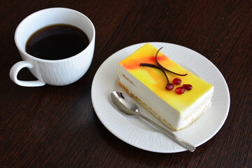 a slice of lemon tart on white saucer top view