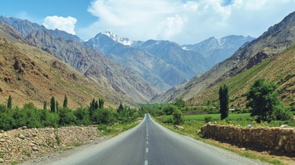 Naklejka premium A long, empty road leading towards towering green mountains, set under a bright blue sky, capturing a sense of adventure.
