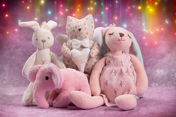 A group of soft toys of different animals on a coloured background