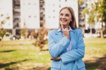 Fototapeta premium Portrait of beautiful businesswoman standing outdoor and thinking. 
