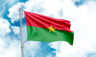 Burkina Faso flag waving on sky background. 3D Rendering