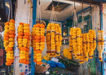 Colourful garlands of marigold flowers hang in the market