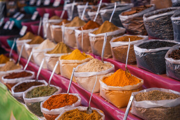 A counter in a store with spices in bags